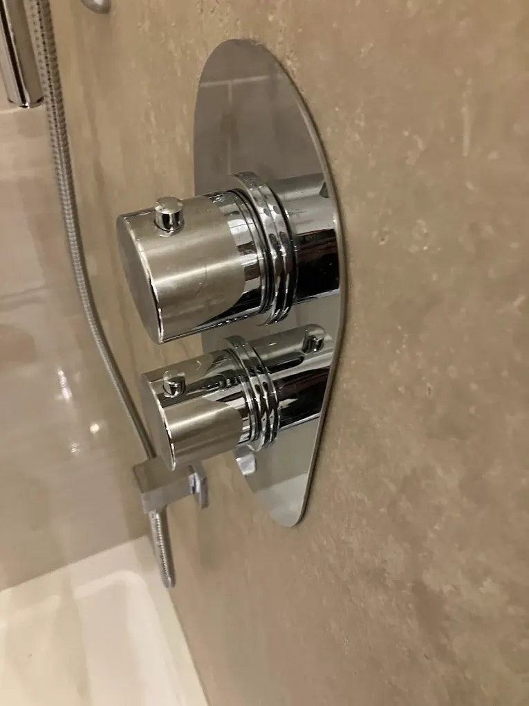 Concealed thermostatic shower valve on tiled wall