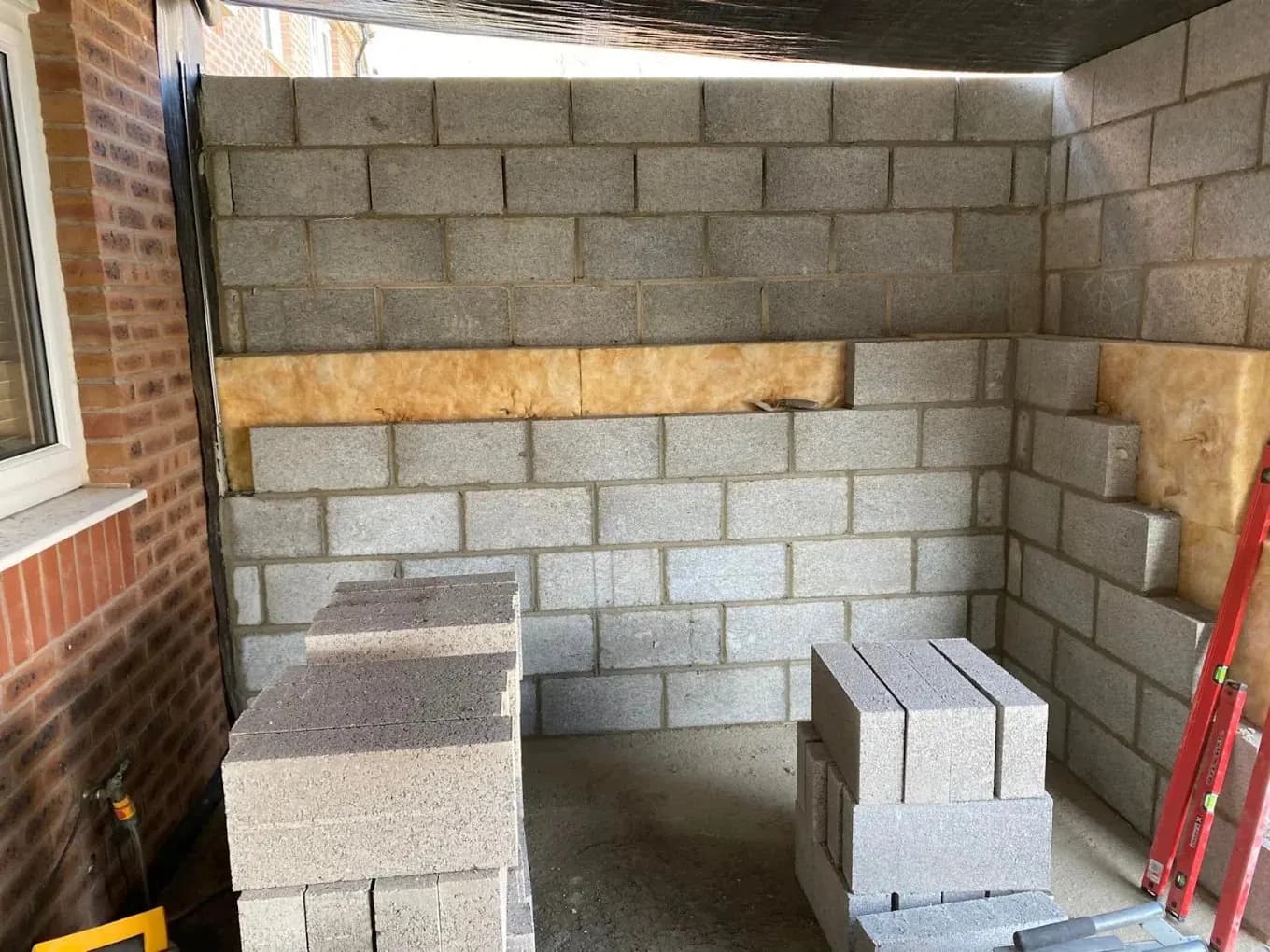 Blockwork extension walls with insulation being built
