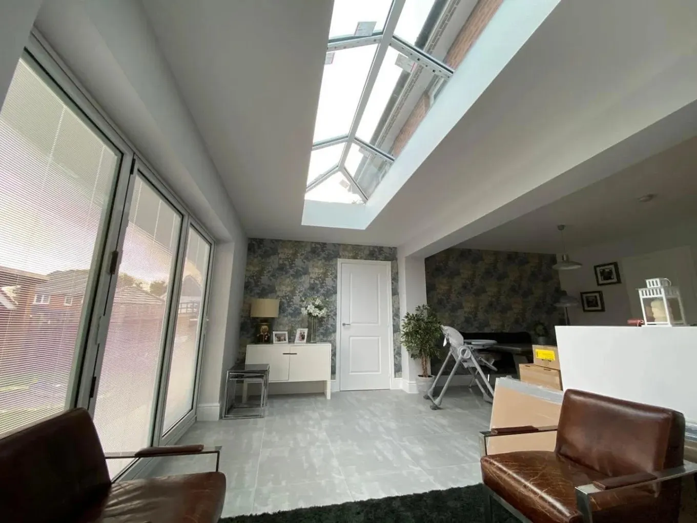 Extension living space with a glazed roof lantern and bi-fold doors, completed in Leeds by CLM Projects