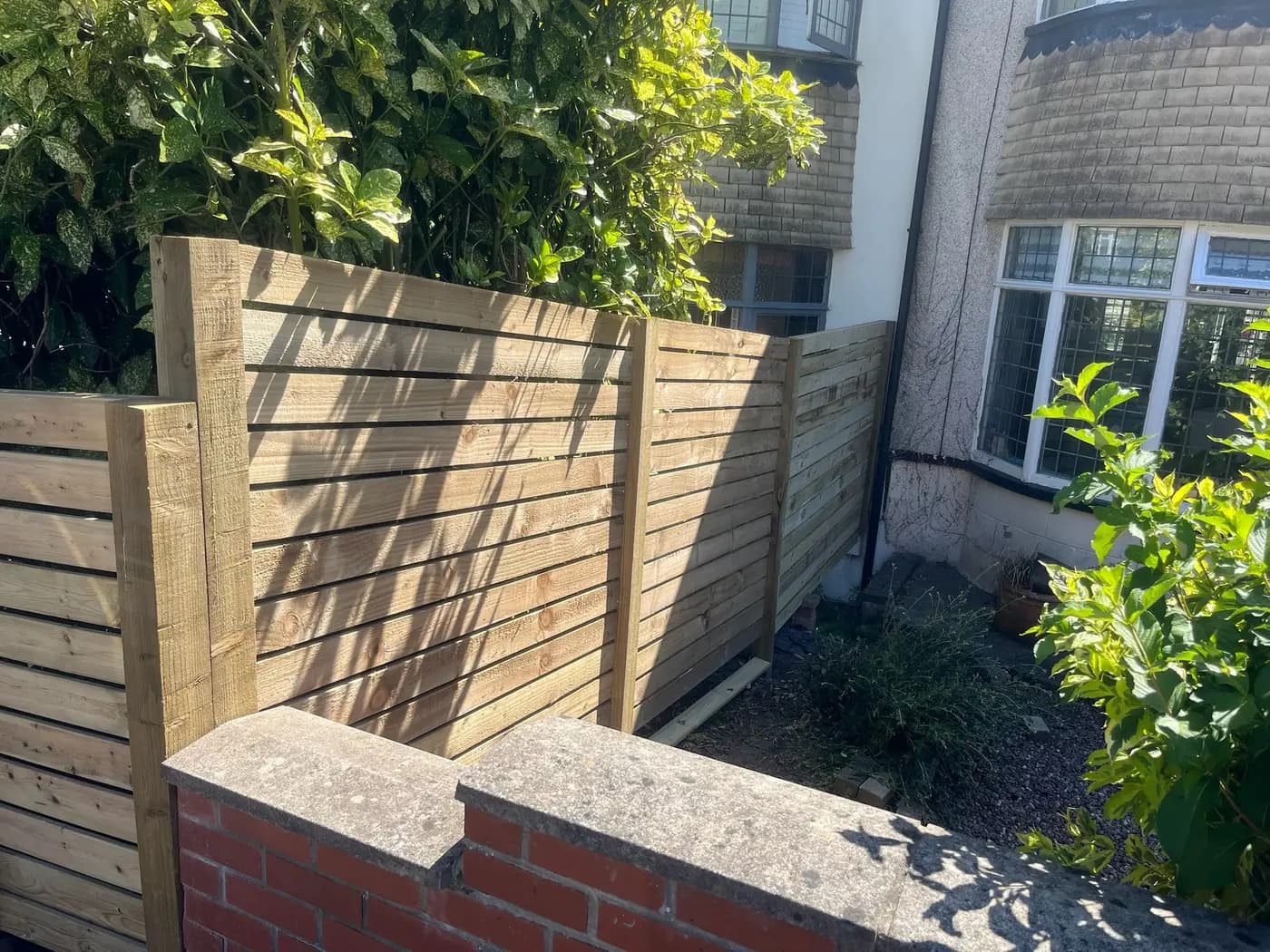 Horizontal slat timber fencing with brick pillar coping, completed in Leeds by CLM Projects