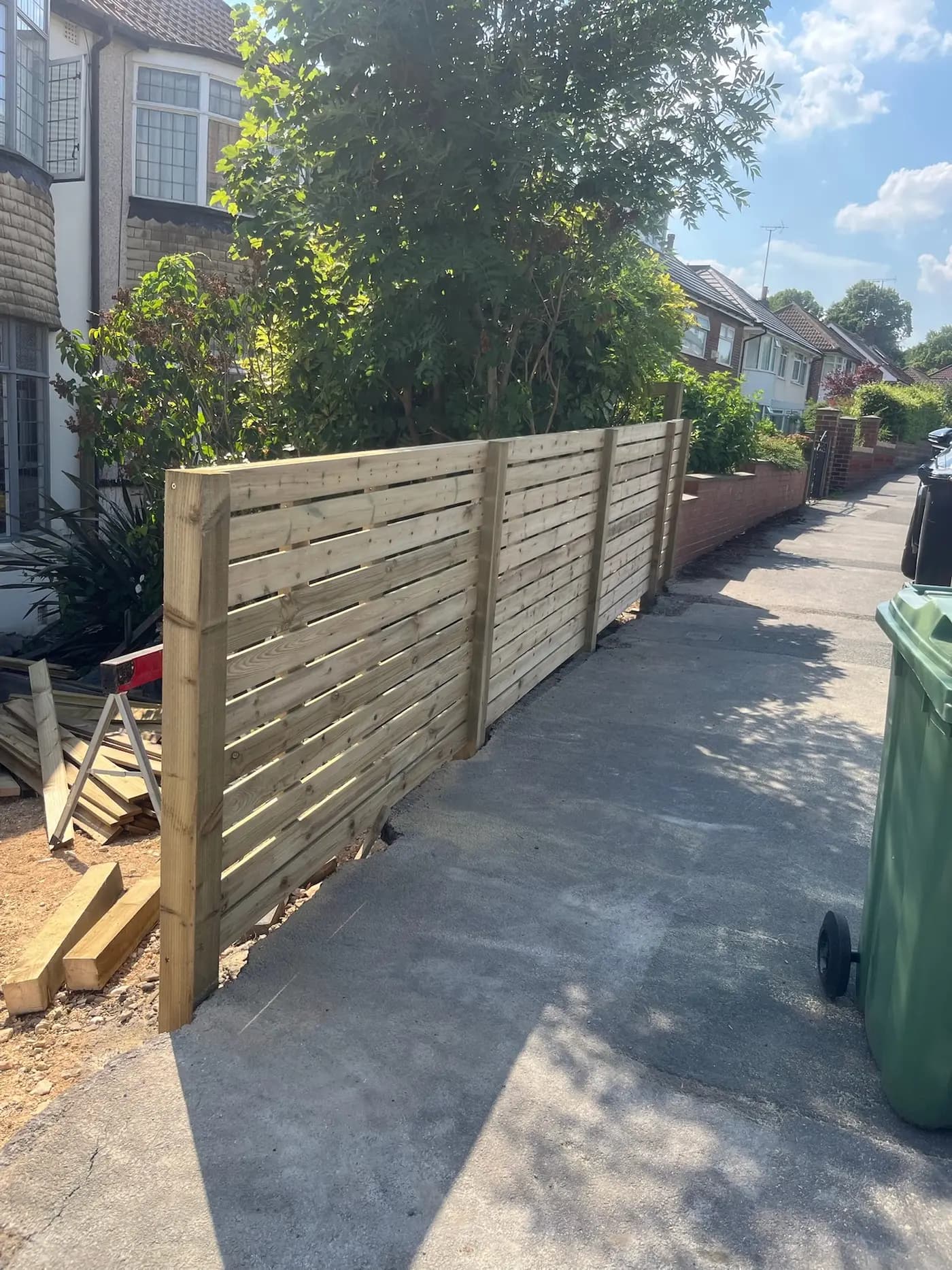 New timber fence panels along a garden path, completed in Leeds by CLM Projects