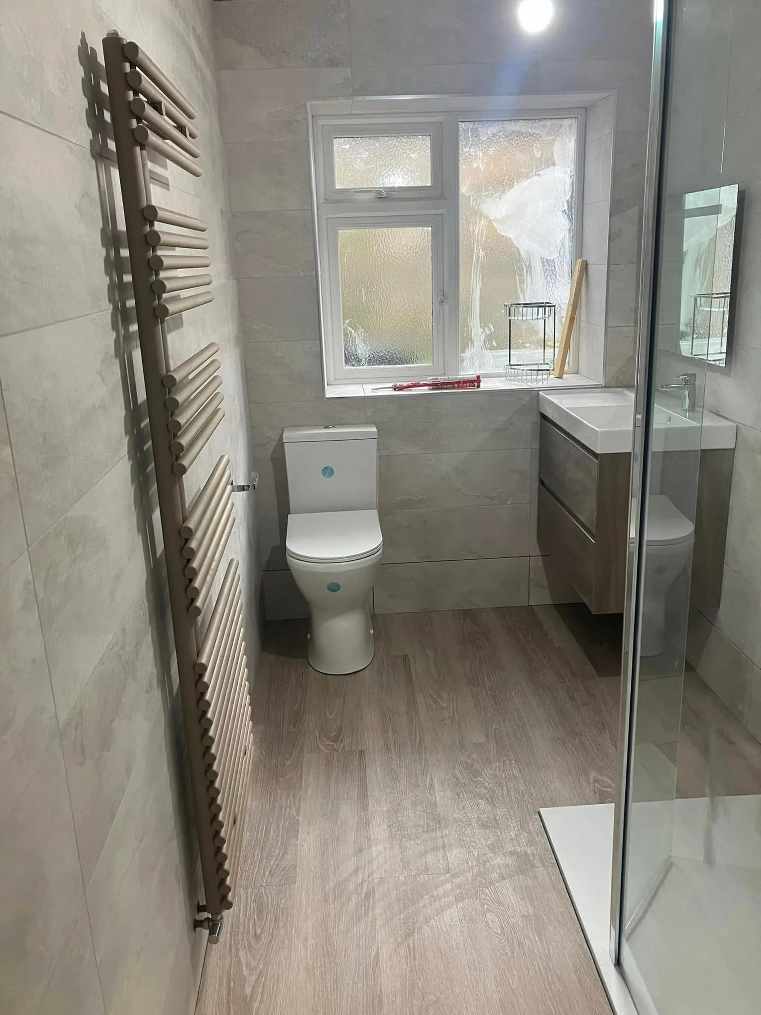 Finished bathroom with vanity unit and toilet suite