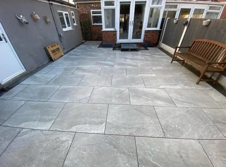 Finished porcelain patio with a garden bench