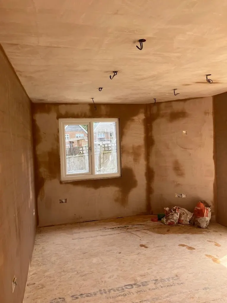 Freshly plastered extension room ready for flooring