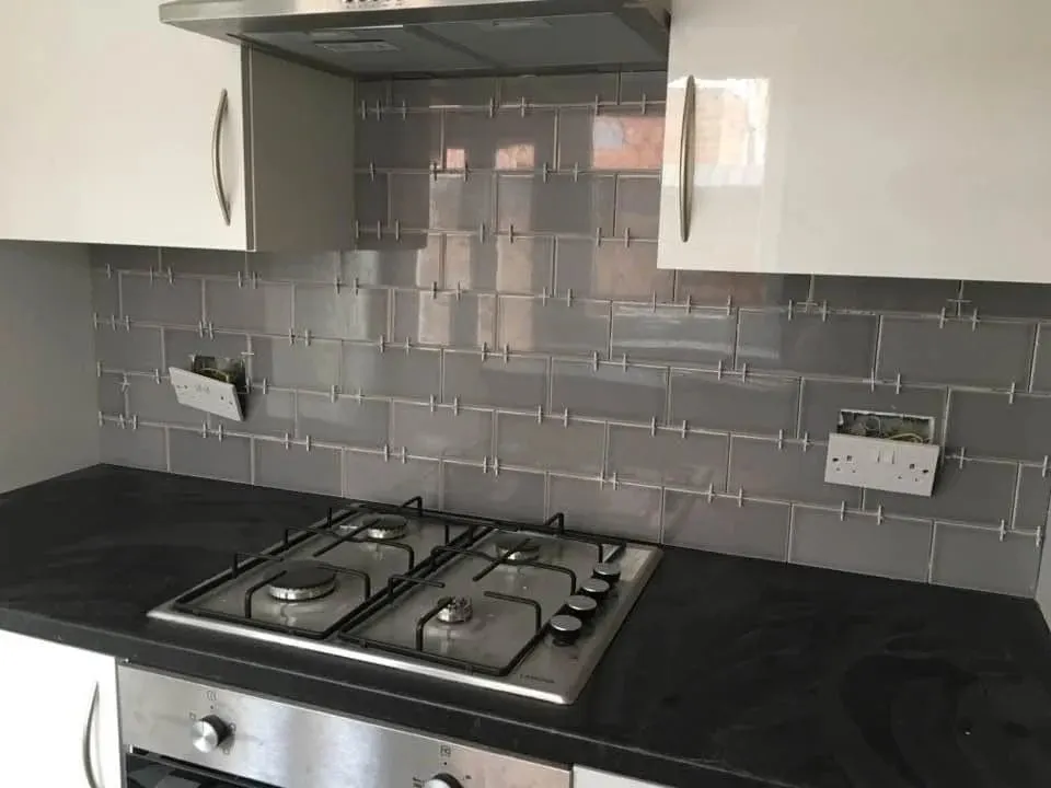 Grey metro tile splashback behind a kitchen hob