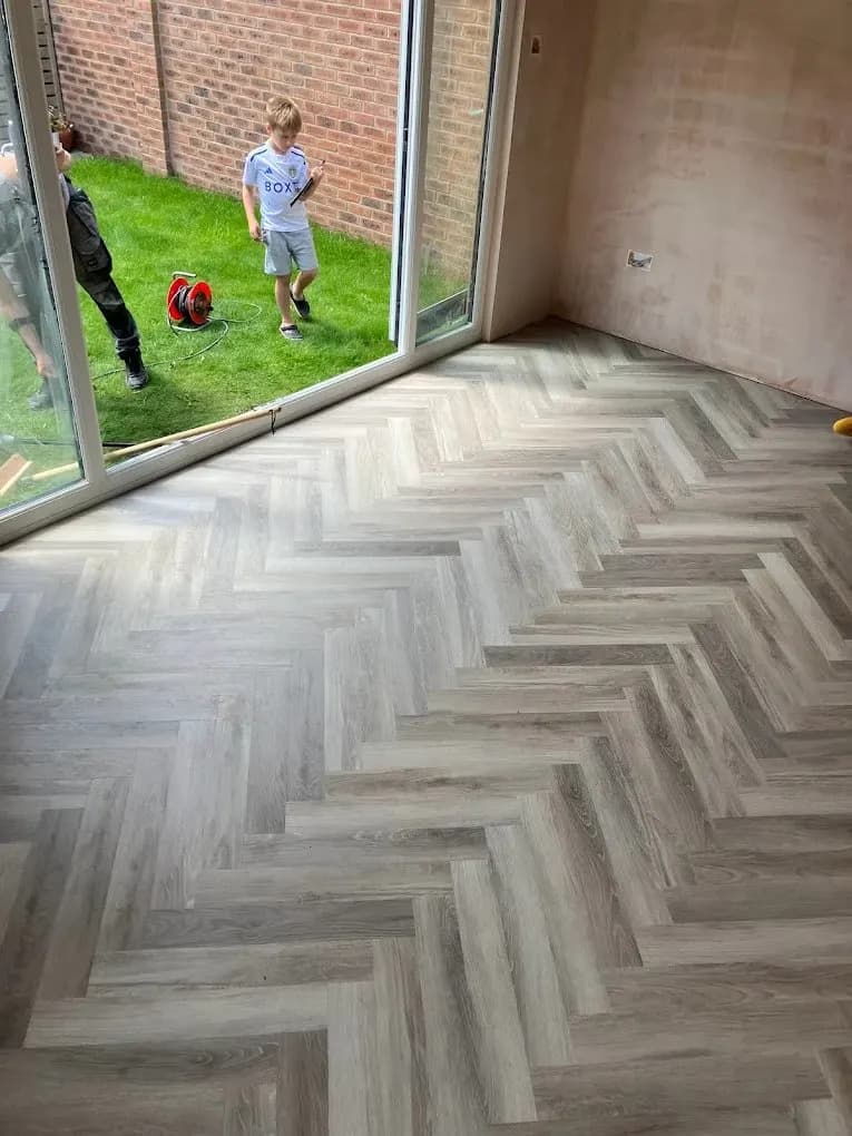 Herringbone flooring installed in a new garden room
