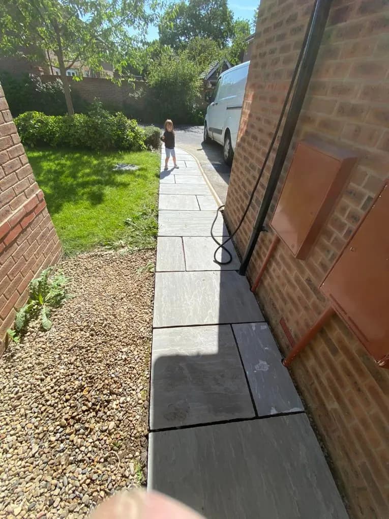 Indian stone paved side pathway along a house