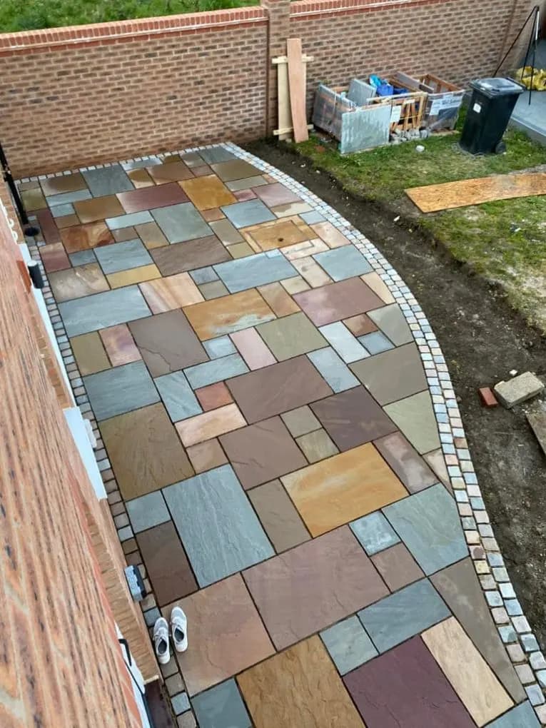 Multi-colour Indian sandstone patio in a rear garden
