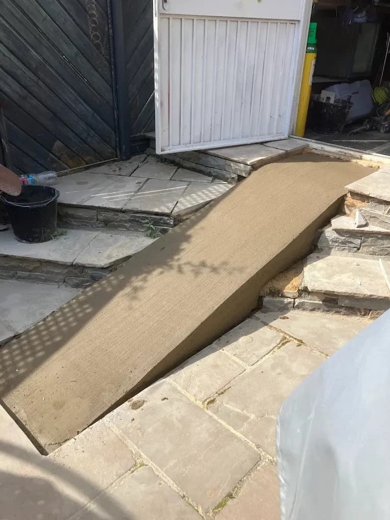 New concrete access ramp at a garage entrance