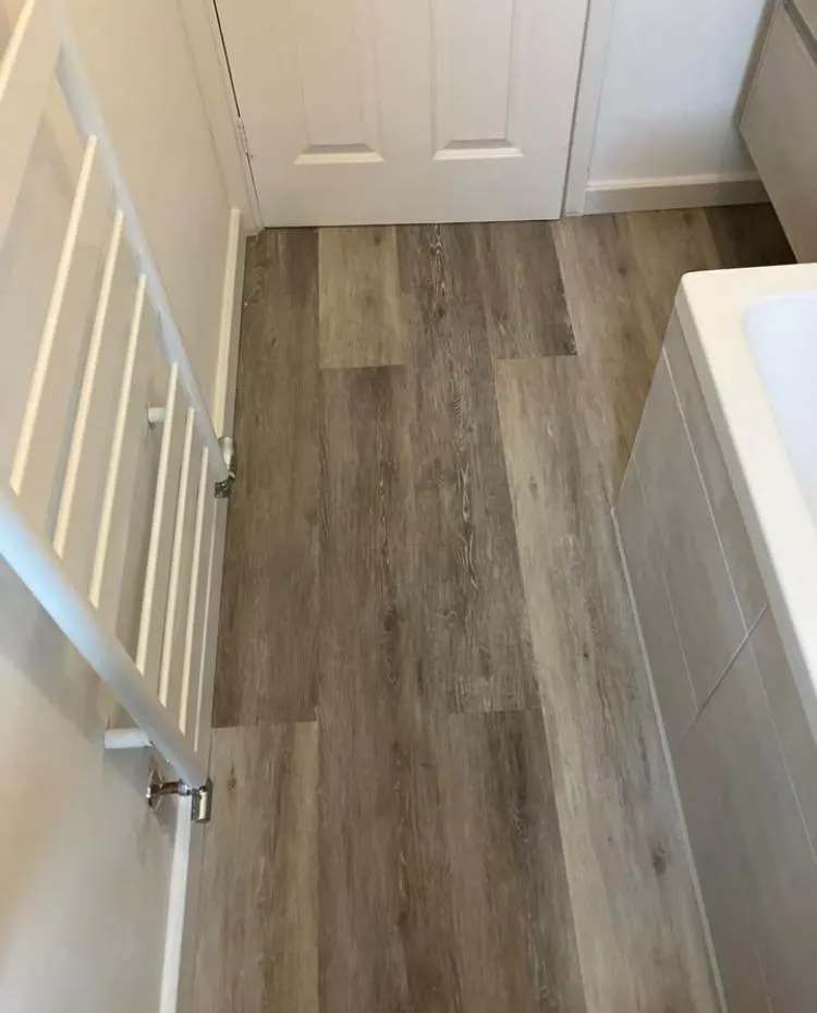 New wood-effect vinyl flooring laid in a bathroom