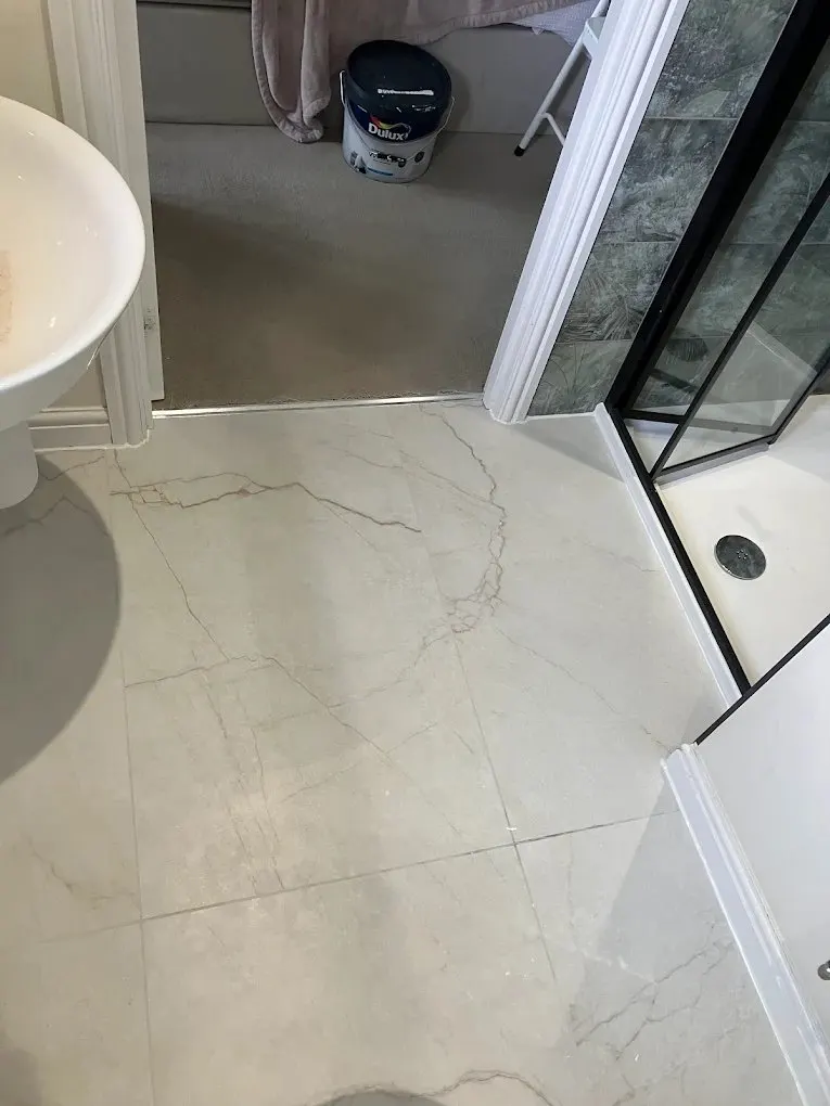 Newly tiled ensuite floor with shower screen