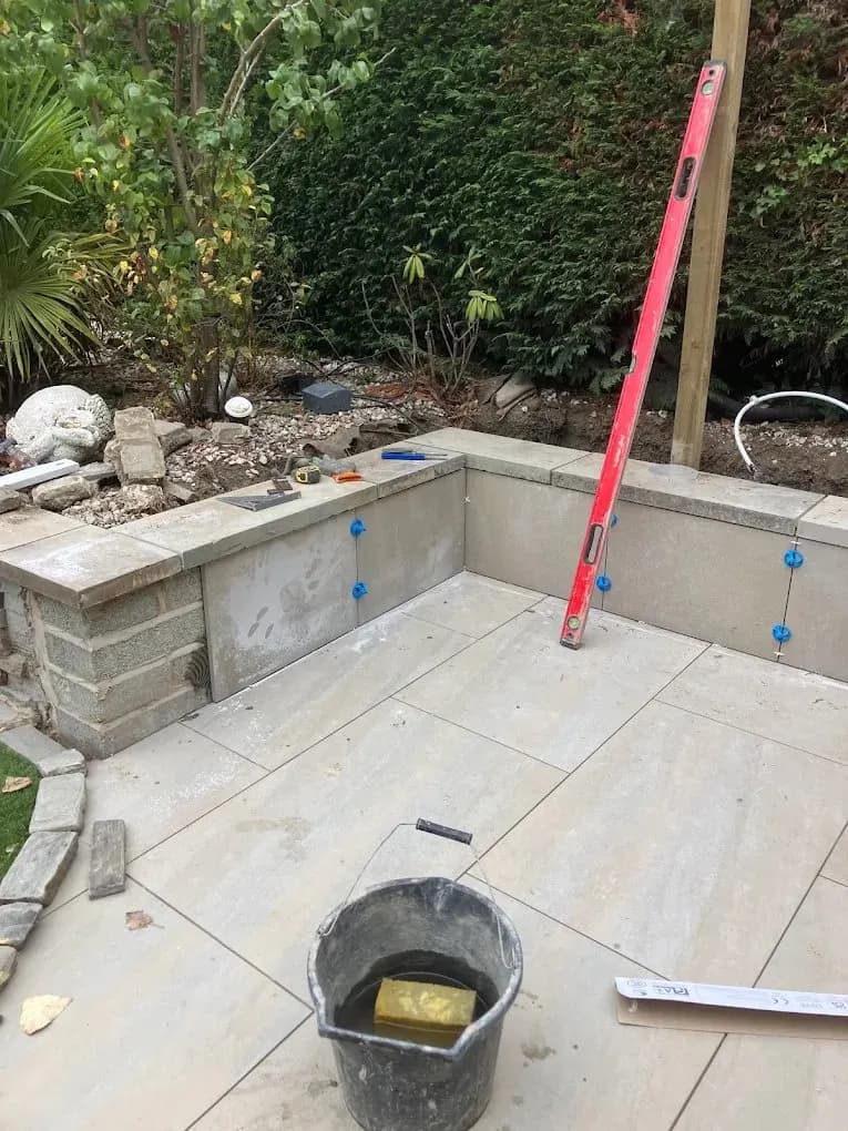 Porcelain patio with a raised wall seating area
