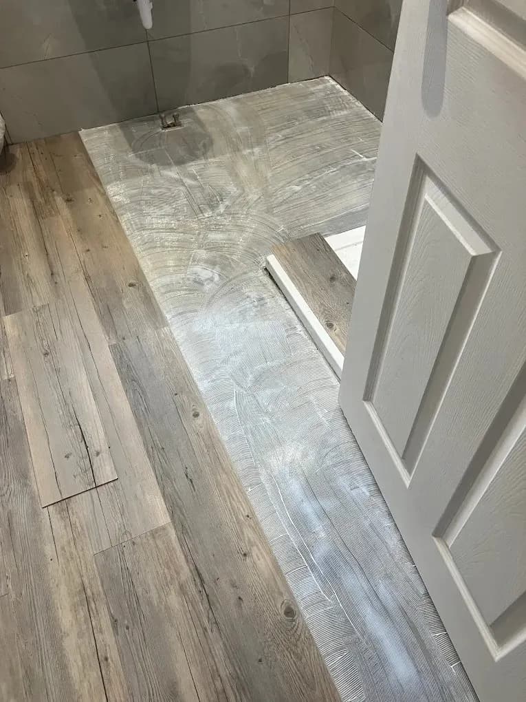Wood-effect vinyl flooring transition at a doorway