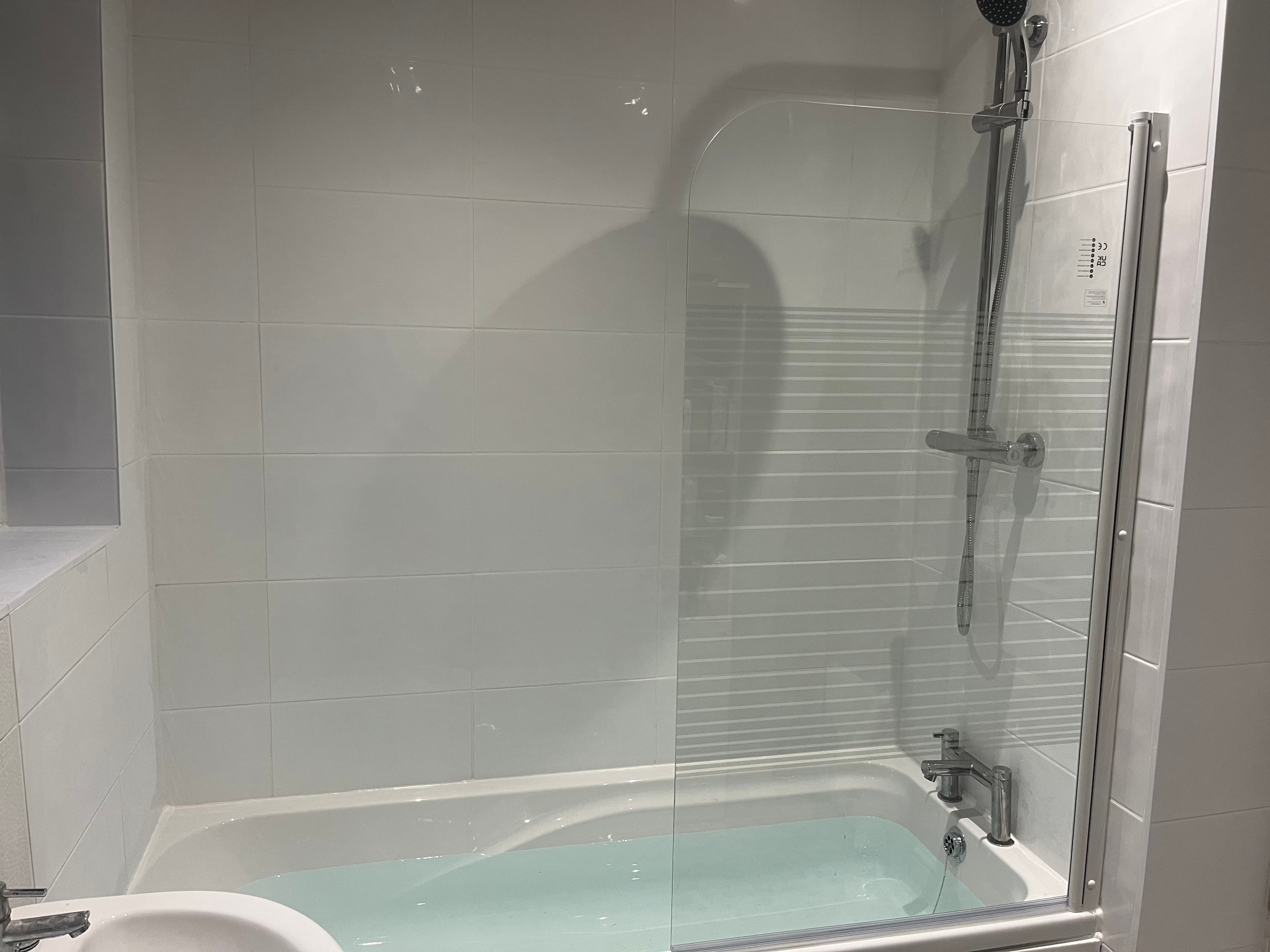 Reinstated bath and shower with new screen and tiled surround